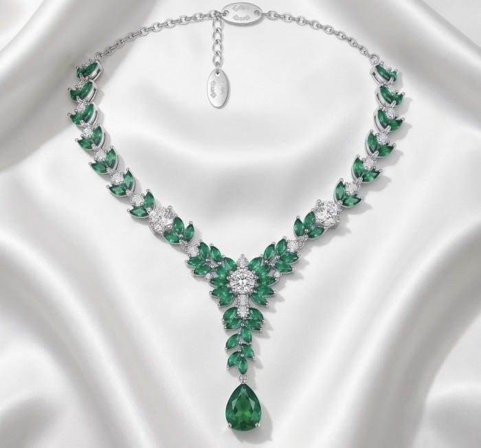 Giovanna - Authentic 12.9 carat COLOMBIAN EMERALD .925 Sterling Silver handcrafted necklace - Colombian emerald necklace on satin, top view, showing chain and pendant.
