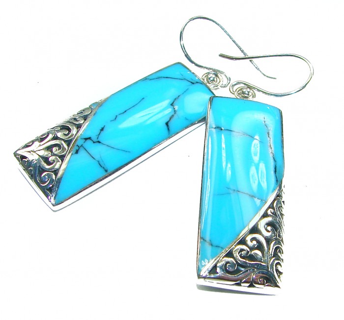 Spectacular Blue inlay Turquoise .925 Sterling Silver handcrafted Earrings - Turquoise earrings, silver swirl detail, angled side view.