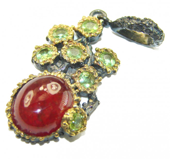 Genuine 4.5 carat Ruby BLACK RHODIUM OVER .925 Sterling Silver handmade Pendant - Close-up of ruby pendant with green gemstones and black rhodium detailing.