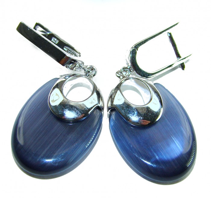 Best quality 12.5 carat African Cats Eye .925 Sterling Silver handcrafted earrings - Earrings with blue cat's eye stones and silver accents, front view.