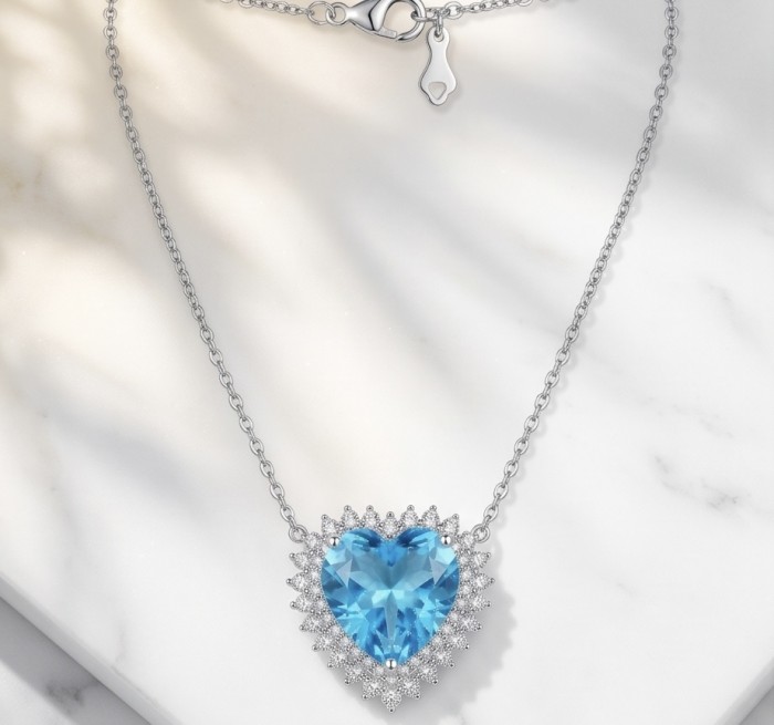 Endless Love 10.5 carat Swiss Blue Topaz .925 Sterling Silver Handcrafted necklace - Heart-shaped blue topaz necklace with close-up of clasp on marble surface.
