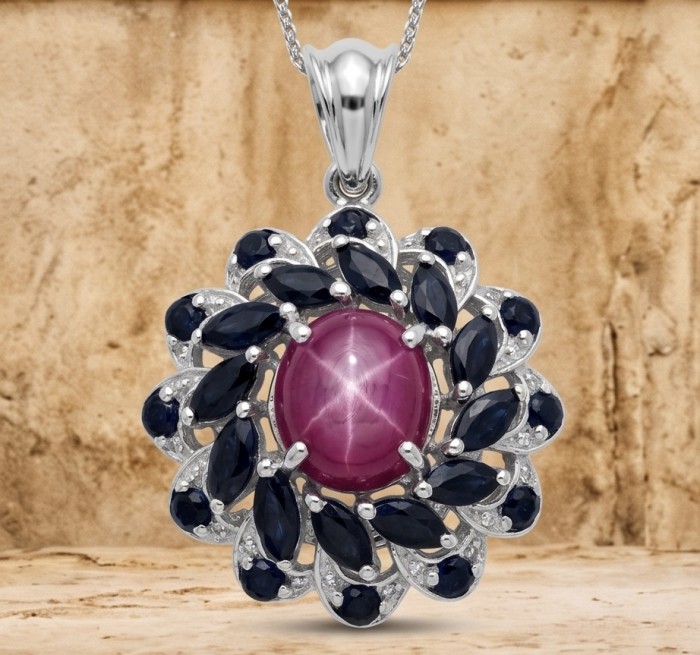 15.2 carat authentic Mozambique Star Ruby rhodium over .925 Sterling Silver handmade Pendant - Close-up of Mozambique Star Ruby pendant with blue stones and rhodium finish