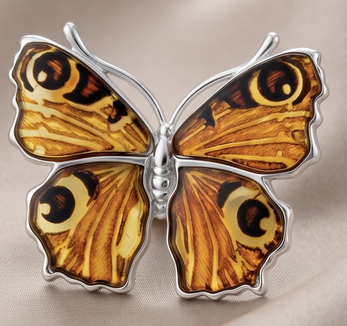 Golden Butterfly Authentic carved Baltic Amber 18K Gold over .925 Sterling Silver handcrafted pendant - Golden butterfly brooch with amber close-up on fabric background