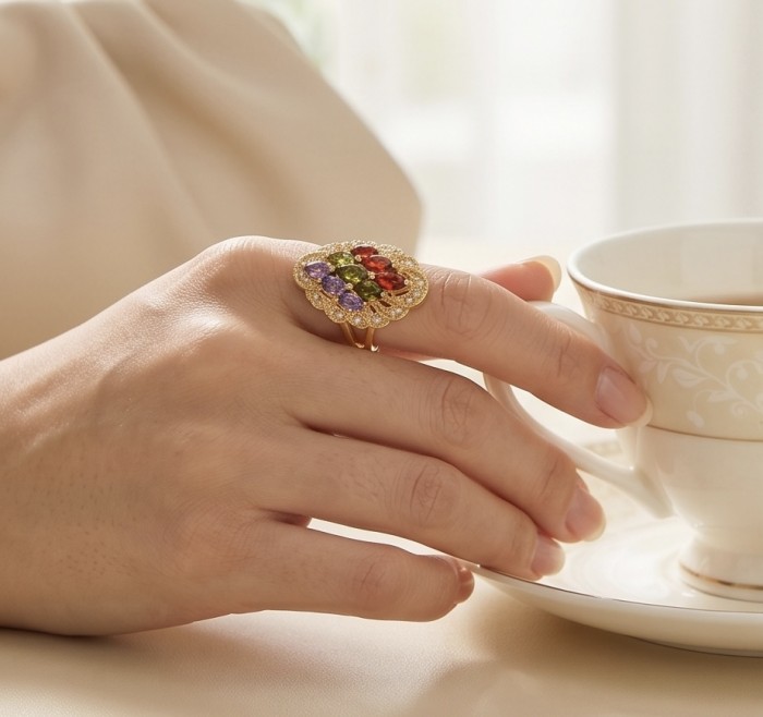 Classy Beauty - authentic 8.7 carat multigem .925 Sterling Silver dipped in 14K Gold Eternity Ring size 6 - Multigem ring worn on hand, holding a teacup, showcasing detail.