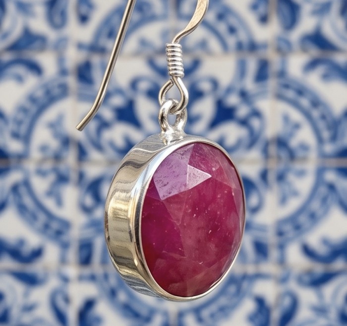 Born to Glam uthentic 15.2 carat Ruby .925 Sterling Silver handcrafted earrings - Close-up of ruby earring in sterling silver setting against tile background.