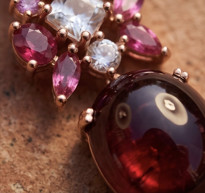 Extravaganza - 12.8 ctw Ruby 22K Rose Gold over .925 Sterling Silver handcrafted Statement handcrafted earrings - Close-up of gemstones on rose gold jewelry piece.