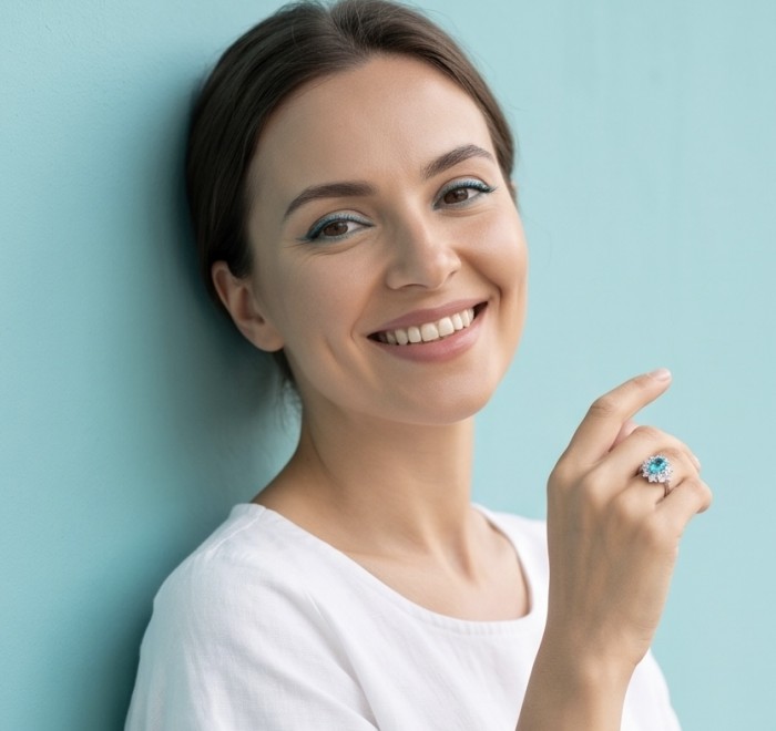 Elizabeth 8.5 carat Paraiba Tourmaline .925 Sterling Silver Handcrafted Ring size 5 - Woman wearing Elizabeth 8.5ct Paraiba Tourmaline ring on hand, smiling.