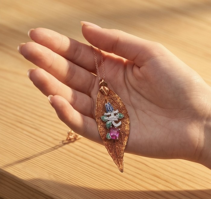 Stylish REAL Leaf dipped in Rose Gold 4.5 carat Garnet .925 Sterling Silver Pendant - Leaf pendant in hand, rose gold, garnet detail, side view