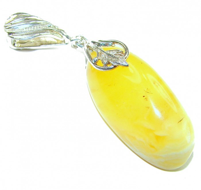 Prehistoric Authentic Buttescotch Baltic Amber .925 Sterling Silver beautifully handcrafted Pendant - Close-up of butterscotch Baltic amber pendant with silver detailing.