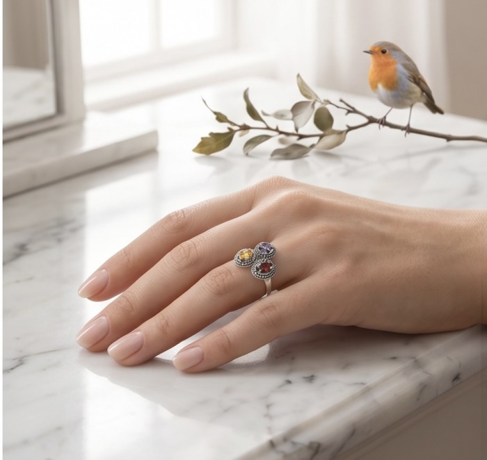 Fiesta Authentic 8.5 carat Multigem .925 Sterling Silver brilliantly handcrafted Ring size 9 - Ring worn on hand, multigem stones on marble with bird nearby