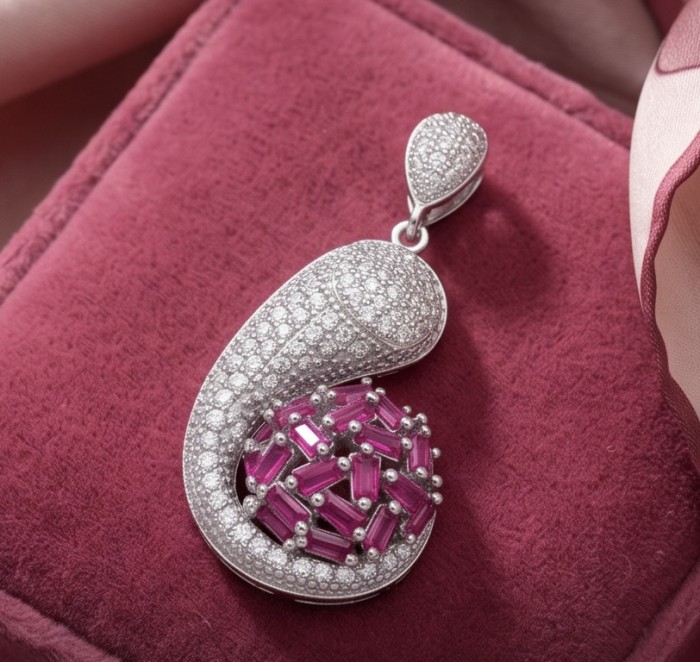 Stella 14.2 carat authentic Mozambique Ruby rhodium over .925 Sterling Silver handmade Pendant - Pendant close-up on pink fabric showing rubies and diamonds.