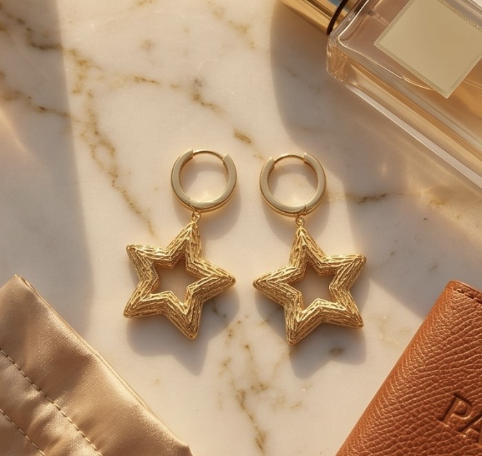 Golden Stars - Dubai Style - .925 Sterling Silver dipped in 22K Gold handmade Earrings - Golden star earrings on marble surface, top view, with accessories.
