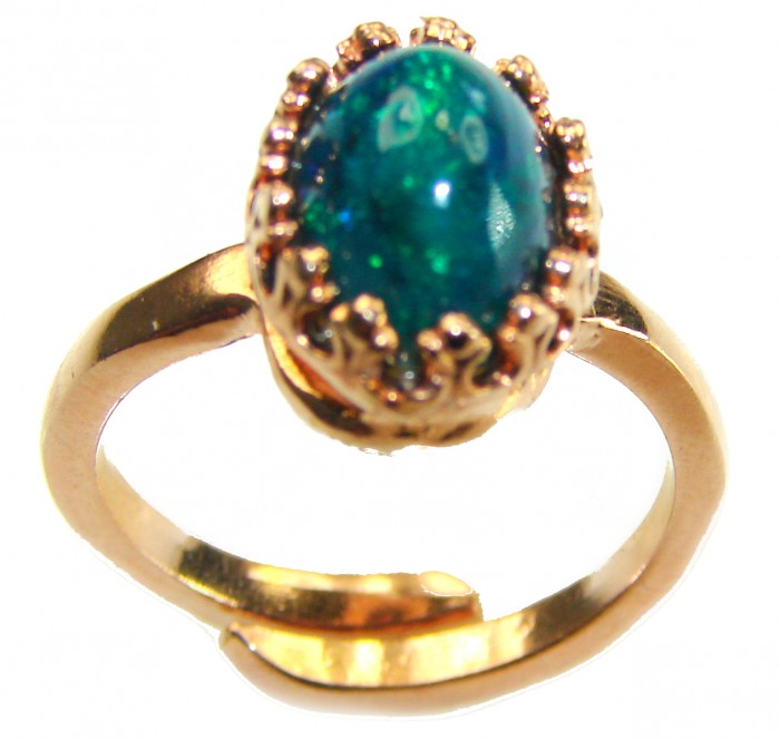 A COSMIC POWER Genuine 4.2 carat Black Opal 18K Gold over .925 Sterling Silver handmade Ring size 7 adjustable - Close-up of a COSMIC POWER Black Opal ring in 18K gold over copper.