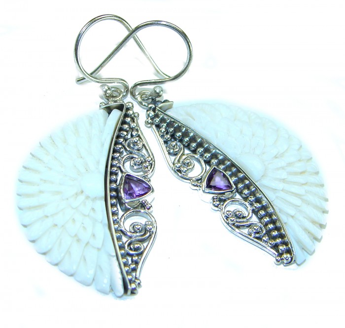 Moonface natural carved Bone .925 Sterling Silver earrings - Carved bone and silver earrings with purple stones, side view.