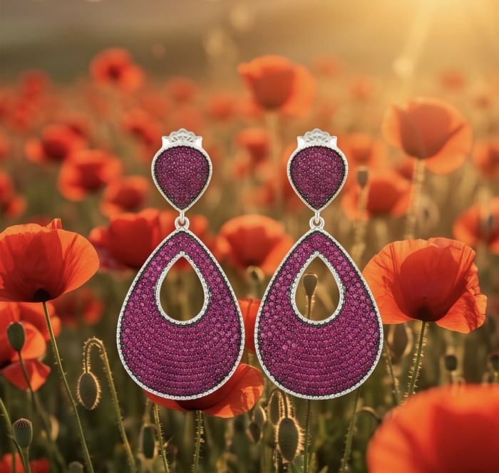 Bella Rossa - 2.5 carat pave Mozambique Ruby .925 Sterling Silver dipped in Rhodium handcrafted earrings - Close-up of Bella Rossa ruby earrings with poppy field background.