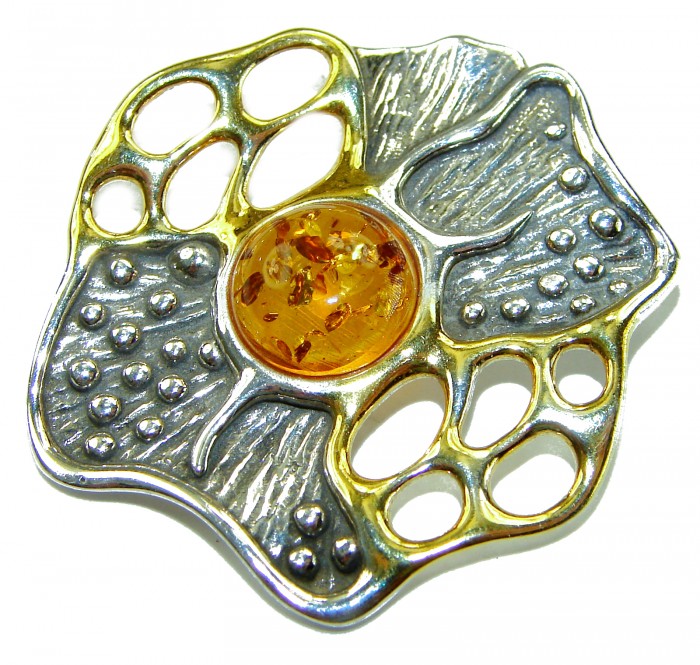 Prehistoric Authentic Baltic Amber 2 tones .925 Sterling Silver beautifully handcrafted Pendant - Close-up of two-tone sterling silver pendant with amber center.