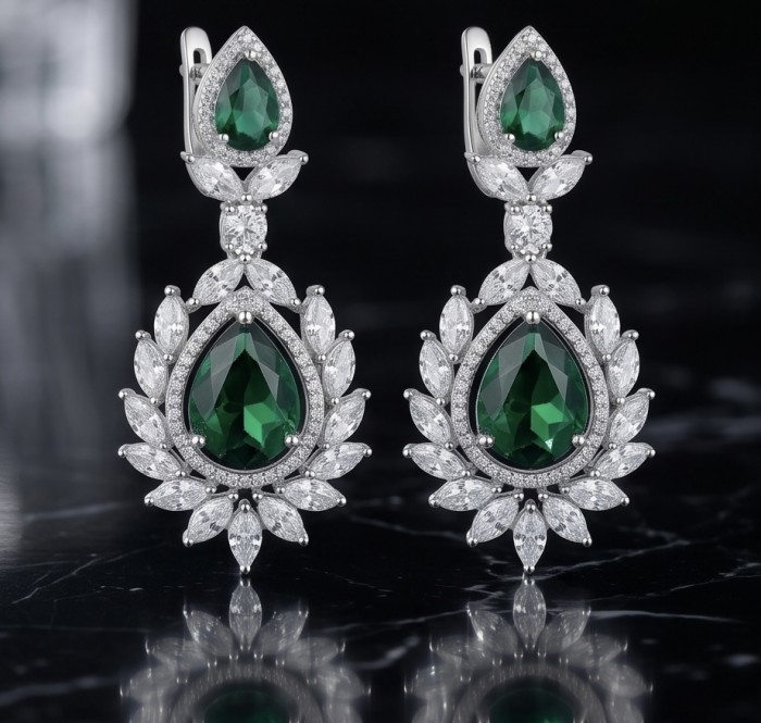 Magnificent Jewel 17.5 carat Emerald 14K white Gold over .925 Sterling Silver handcrafted earrings - Elegant drop earrings with emerald and diamond accents on black background.