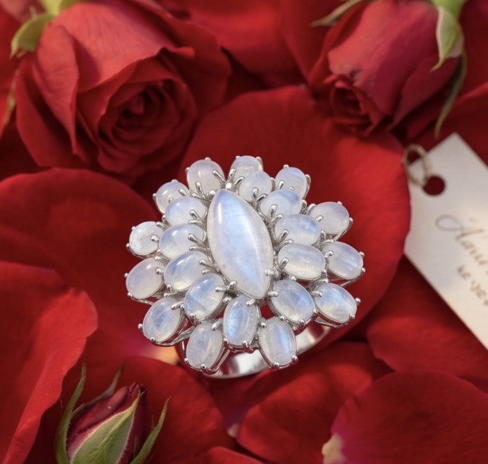 Large Blue Cascade 29.5 carat Rainbow Moonstone rhodium over .925 Sterling Silver handmade ring s. 6 - Ring with rainbow moonstones and rhodium on red rose petals, top view.