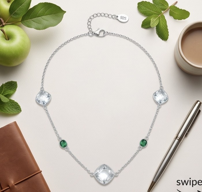 Infinity 11.5 carat Authentic Multigems Rhodium over .925 Sterling Silver handcrafted Statement necklace - Silver necklace with multigem detail, top view, surrounded by apples and mint.