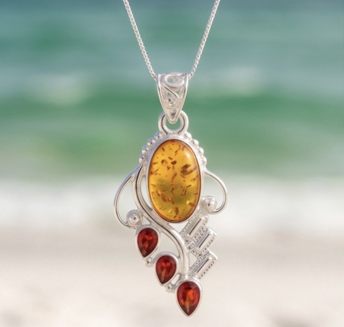 Sea Treasure Prehistoric Authentic Golden Baltic Amber .925 Sterling Silver beautifully handcrafted Pendant - Close-up of Sea Treasure Amber pendant with red stones, silver setting