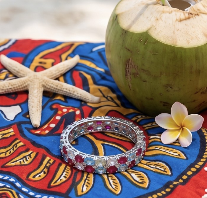 Fiesta Authentic 51.2 carat Morganite Ruby Swiss Blue Topaz .925 Sterling Silver handmade bangle Bracelet - Fiesta bracelet with gems on colorful cloth, starfish, and coconut background.