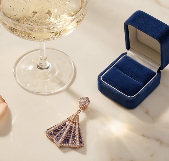 Luxurious 5.2 carat Sapphire .925 Sterling Silver dipped in 18K Rose Gold handmade Pendant - Fan-shaped sapphire pendant and open blue velvet box on marble surface.