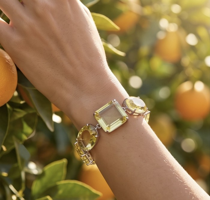 Luxurious Genuine 55.2 CARAT Lemon Quartz .925 Sterling Silver handcrafted Bracelet - Lemon Quartz bracelet on wrist amidst orange tree background.