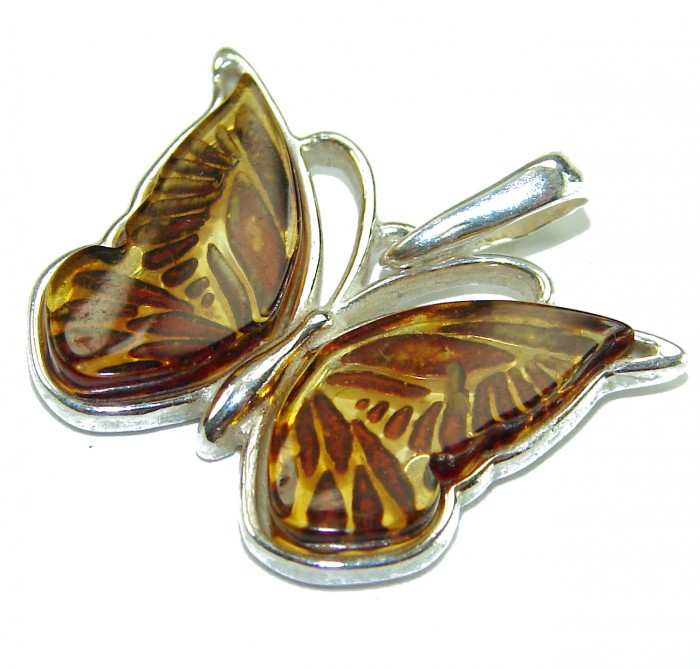 Cute Butterfly Authentic carved Baltic Amber .925 Sterling Silver handcrafted pendant - Butterfly amber pendant in sterling silver, angled view.