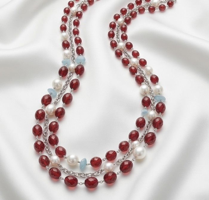 Sublime 32 inches long Red Fossilized Coral handmade Necklace - Red fossilized coral necklace on white fabric, top view.