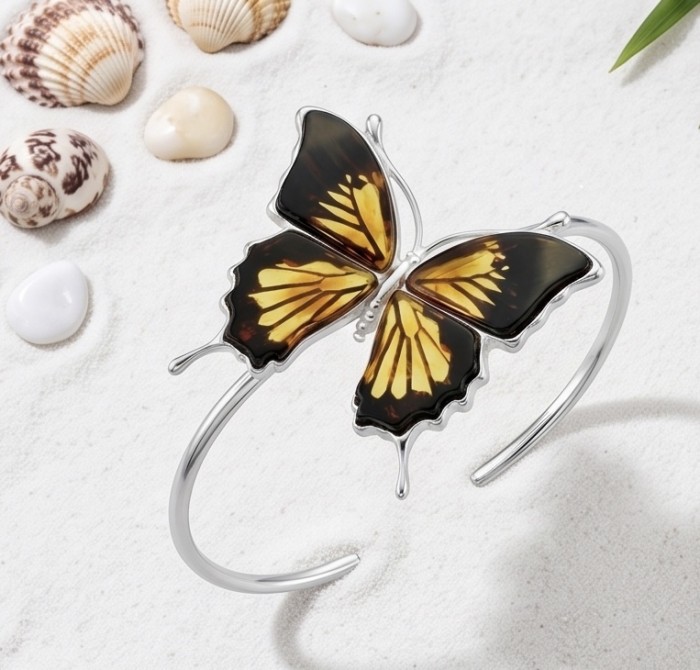 Golden carved Butterfly Genuine Baltic Amber .925 Sterling Silver handamde Bracelet - Butterfly amber bracelet on sand with shells, top view.
