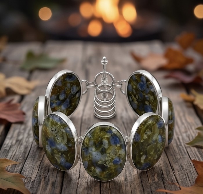 Bochemian Style Beauty 149.5 carat Rare Stichtite .925 Sterling Silver handcrafted Bracelet - Bracelet with oval Stichtite stones on wood, autumn leaves background.