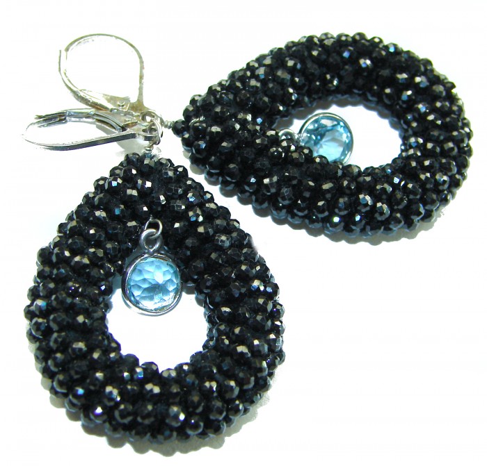 Spiritual Rebirth Precious genuine 29.7 CARAT Black Spinel .925 Sterling Silver STATAMENT earrings - Close-up of drop-shaped black spinel earrings with blue stones.