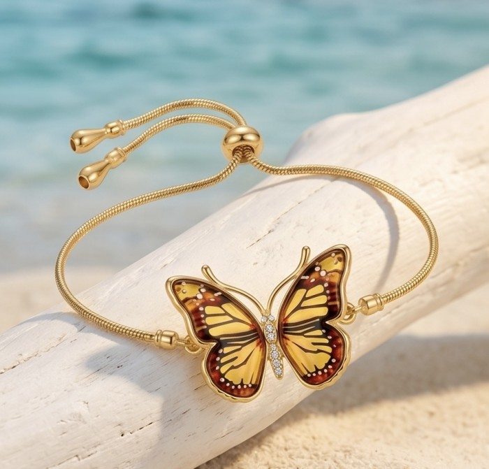 Golden Butterfly Genuine carved Baltic Amber 18K Gold over .925 Sterling Silver handamde Bracelet - Golden butterfly bracelet on driftwood, beach background, top view.