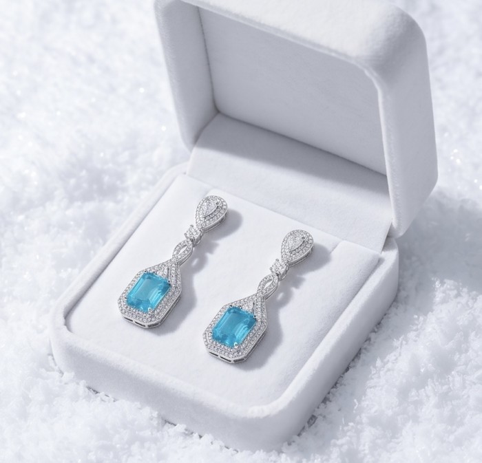 Bellissima Incredible 12.5 carat Paraiba Tourmaline .925 Sterling Silver entirely handmade earrings - Earrings with Paraiba tourmaline in open box on a snowy background.