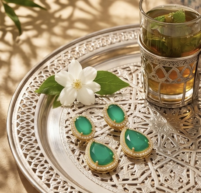 Giovanna - Authentic 10.9 carat COLOMBIAN EMERALD .925 Sterling Silver dipped in 22K Gold handcrafted earrings - Jewelry display on ornate tray with emeralds and tea glass, top view.