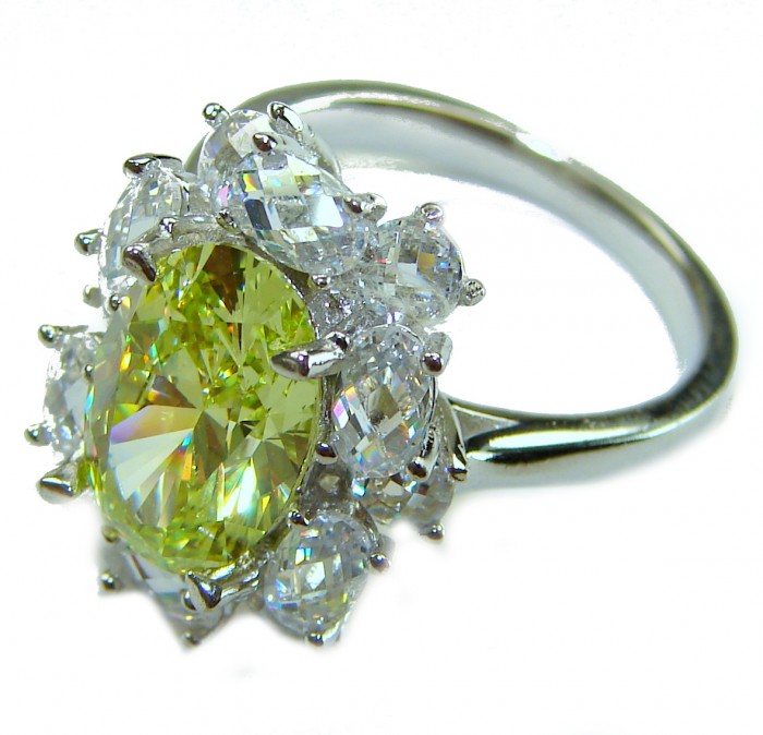 Splendid princess cut 10.2 carat yellow Sapphire .925 Sterling Silver brilliantly handcrafted ring s. 7 1/4 - Yellow sapphire ring with surrounding stones, angled side view.