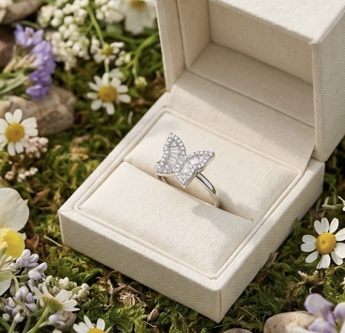 White Butterfly natural 2.5 carat Topaz .925 Sterling Silver handmade Ring size 8 1/4 - Butterfly topaz ring in box, top view, surrounded by flowers.