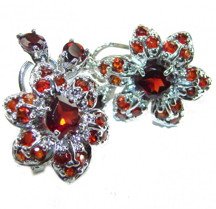 Penelope Authentic 22.5 carat faceted Garnet .925 Sterling Silver handcrafted earrings - Close-up of floral design garnet earrings in sterling silver.