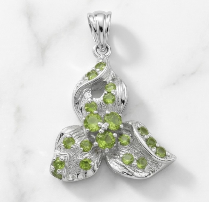 AMAZONIA Authentic 8.5 CARAT Chrome Diopside .925 Sterling Silver Pendant - Pendant with green stones on silver, front view, marble background.