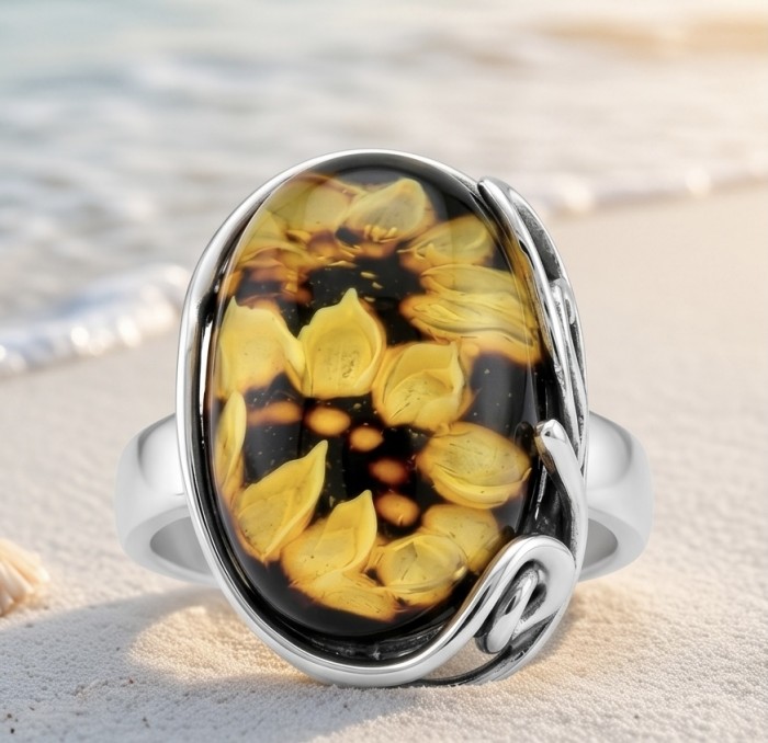 Beautiful Authentic Funflowers carved Baltic Amber .925 Sterling Silver handcrafted ring; s. 7 adjustable - Close-up of Baltic amber ring with carved sunflower design on a sandy beach.