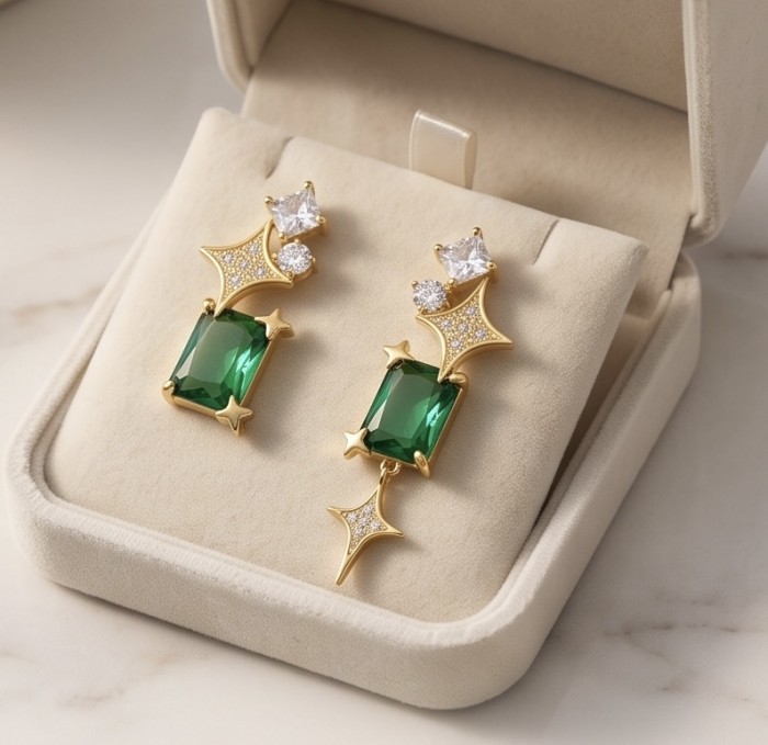 Green Dreamland 9.9 carat authentic Himalayan Peridot .925 Sterling Silver Handcrafted Asymmetrical Statement Earrings - Gold earrings with green gemstones, close-up in a jewelry box.