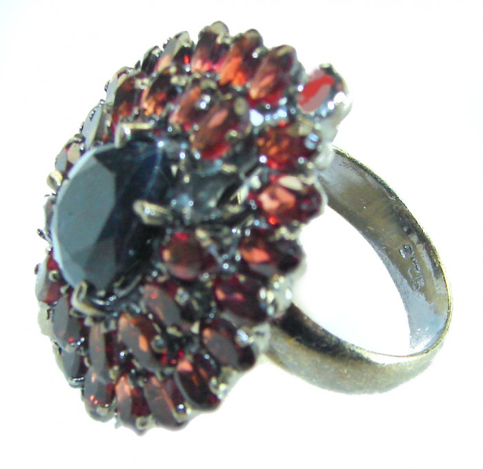 Blue Odyssey 22.5 carat authentic Sapphire black rhodium over .925 Silver handcrafted Cocktail Ring s. 8 1/2 - Side view of a Blue Odyssey 22.5 carat sapphire ring with red stones