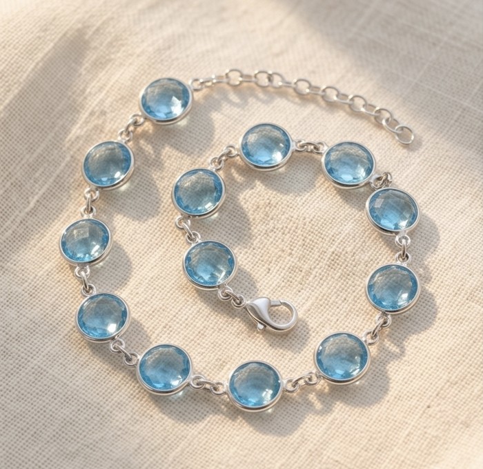Authentic 10.5 carat Swiss Blue Topaz .925 Sterling Silver handmade Bracelet - Swiss Blue Topaz bracelet in sunlight, showcasing stones and clasp detail.