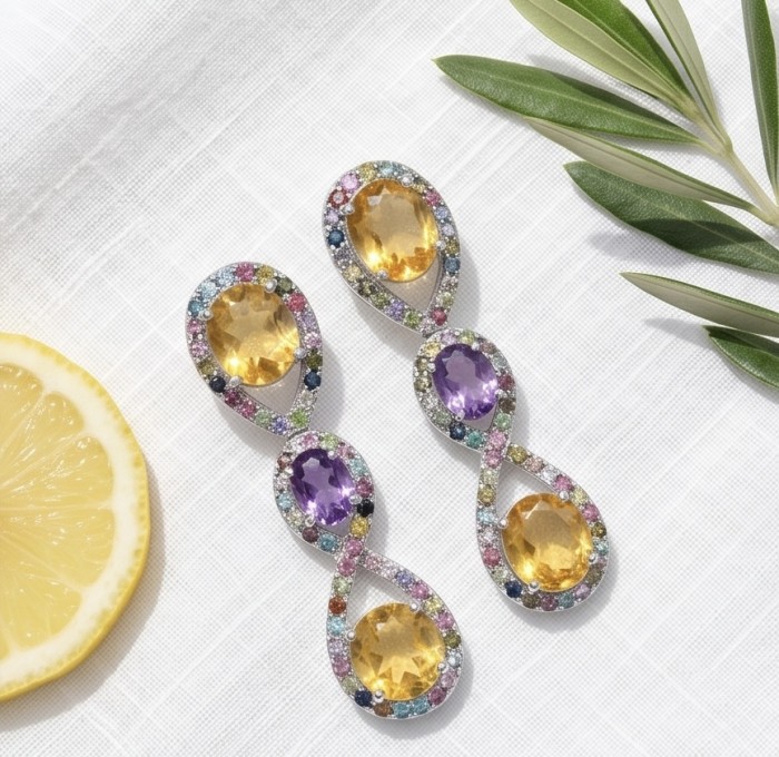Exclusive 14.5 carat Brazilian Citine rhodium over .925 Sterling Silver handcrafted Earrings - Dangling earrings with citrine and amethyst on white fabric, top view.