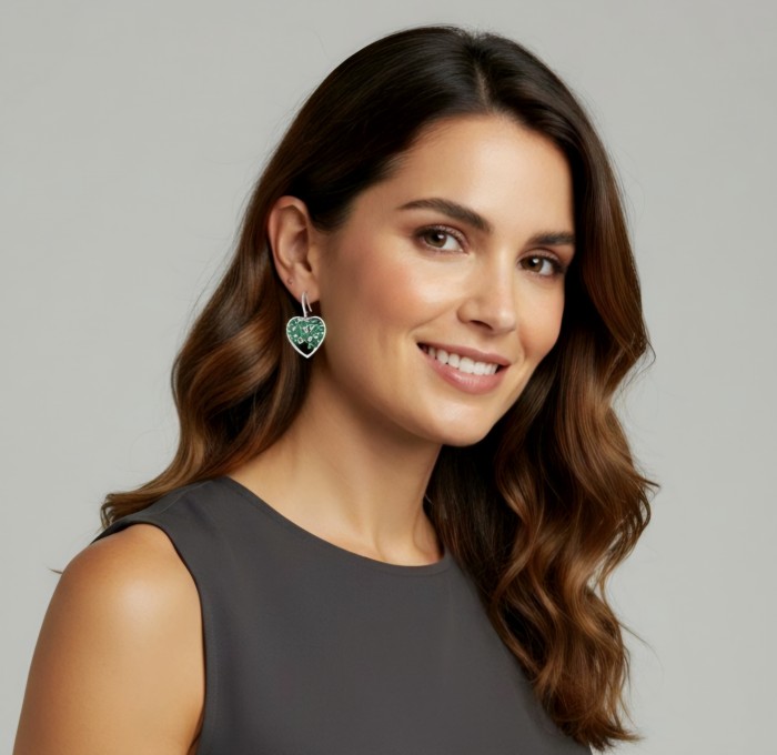 Hearts Wonderful natural Tsavorite Gasrnet rhodium over .925 Sterling Silver entirely handcrafted earrings - Woman wearing heart-shaped Tsavorite Garnet earrings, side view.