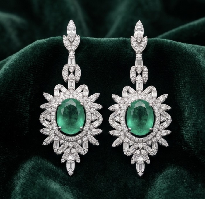 Luxurious - 7.8 carat Colombian Emerald .925 Sterling Silver dipped in rhodium handmade Statement Earrings - Front view of Exotic Flowers emerald earrings on green velvet background