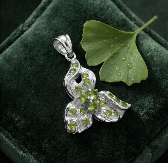 AMAZONIA Authentic 8.5 CARAT Chrome Diopside .925 Sterling Silver Pendant - Pendant on velvet with green leaf, showcasing stones and silver detailing.