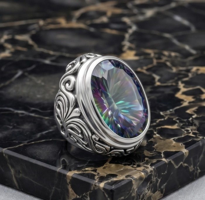 Big Dreamer 29.8 carat Mystic Topaz .925 Sterling Silver handcrafted Large ring size 8 - Ornate ring with 29.8 ct Mystic Topaz on marble background, side view