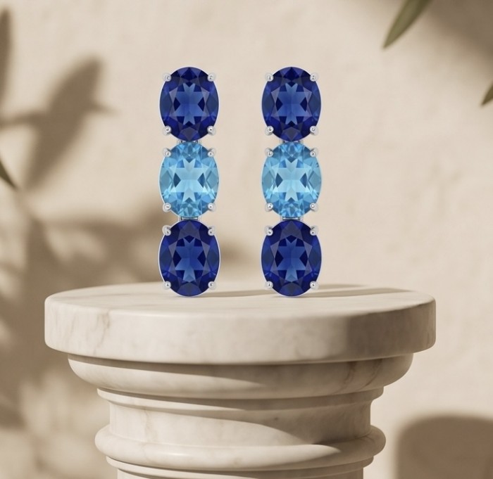 Oceania - 22.5 carat London Blue Topaz .925 Sterling Silver handmade Statement earrings - Front view of Oceania blue topaz earrings on a pedestal.