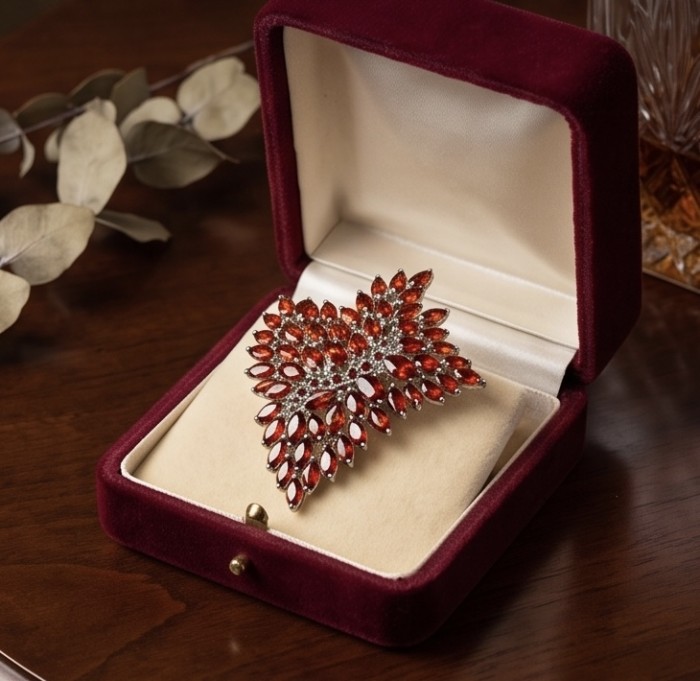 Mademoiselle - Vintage Design 30.2 CARAT Brazilian Garnet rhodium over .925 Sterling Silver handcrafted Pendant & Brooch - Top view of Mademoiselle vintage brooch in velvet box on wooden table.